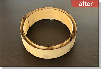 円形のウォールシェルフの側面を丸めて、テープで仮止めした状態の写真